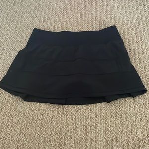 A black Lululemon Pace Rival skirt (regular).